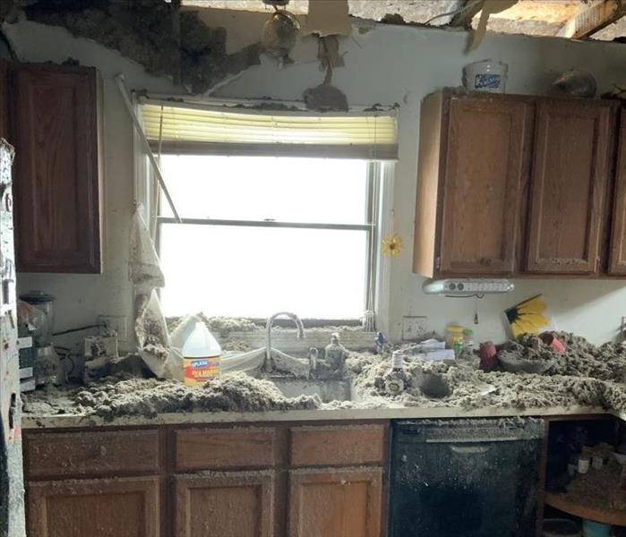 Kitchen fire with ceiling collapsed and insulation everywhere