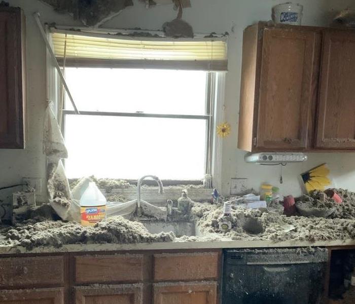 A kitchen that had a fire with insulation everywhere and exposed ceiling joists